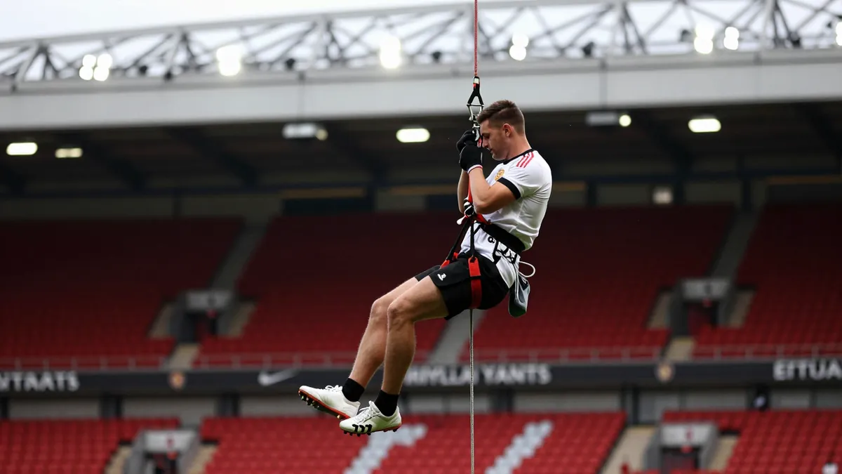 Leeds United fans participate in an abseil event at Elland Road, raising over £15,000 for the club's official charity and...