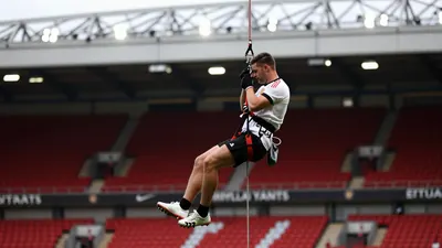 Leeds United fans participate in an abseil event at Elland Road, raising over £15,000 for the club's official charity and...